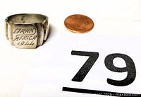 Front view of ring showing ORAN AFRICA 1944 engraving beside coin