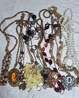 Assorted ten costume necklaces laid out showing styles, colors and materials