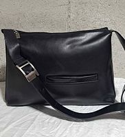 Front view of black leather Mario Valentino crossbody bag with zip closure and adjustable strap