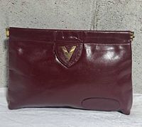 Front view showing burgundy leather, gold V logo plaque