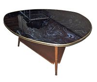 Oblique view showing resin top pattern, brass edge, wooden legs, lower shelf