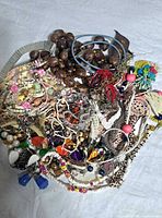 Pile of assorted costume jewellery necklaces showing variety of colours, materials and styles
