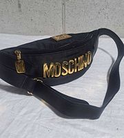 Front view showing gold MOSCHINO lettering, zipper and strap
