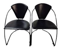 Front view of both black faux-leather dining chairs