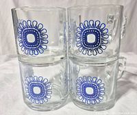 Front view of four stacked Nutella glass mugs