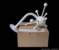 Side view showing curved wall arm and spherical hub with arms