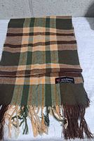 Full view of plaid cashmere scarf showing colour pattern and fringe