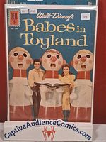 Front cover of Dell Four Color #1282 Walt Disney's Babes in Toyland comic book in bag with price and grade stickers