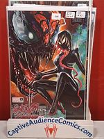 Front view of bagged Gwenom vs Carnage #1 Greg Horn variant comic on display stand