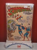 Front cover of Superman #169 in bag on display stand