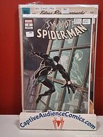 Front view of Symbiote Spider-Man #1 variant comic in bag and board on display stand