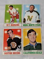 Front view of all four 1970-71 Topps hockey cards