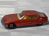 Driver side view of metallic red Matchbox Lesney Citroen die-cast car