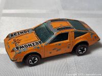 Left front and side view showing decals, redline wheels, paint loss.