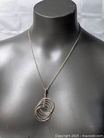 Necklace draped on bust, full view showing chain length and pendant