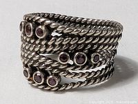Front view showing twisted rope bands and bezel-set amethyst stones