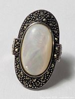 Front view of ring showing mother-of-pearl cabochon and marcasite border