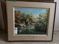 Front view of framed Anne Doyle river landscape oil painting