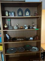 Full bookshelf view showing assortment of items described