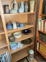 Multiple shelves showing entire assortment of stoneware pieces