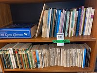 Two-shelf view showing boxed opera librettos and rows of small paperback poetry volumes