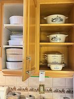 Cabinet view showing all casseroles stacked on shelves