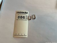 Lot overview with both earrings beside lot card