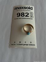 Gold ring with turquoise stone on MaxSold lot card