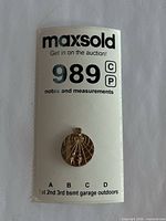 Pendant on auction card showing lot number and full view