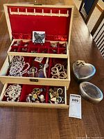 Open jewelry box showing contents and trinket boxes