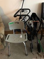 Group shot of rollator, folding walker, shower chair, cane