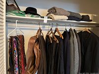 Closet rod with jackets, ties, belts, sweaters, hats and handkerchiefs