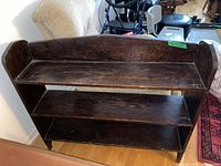 Front view of dark brown three-shelf wooden bookcase