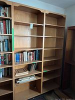 Front view of first bookshelf with shelves and some excluded books