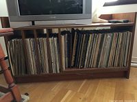 Full front view showing stand with LPs and TV on top