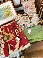 Overall lot view: rug, quilt, green blanket, throw pillow