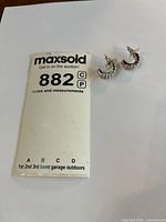 Pair of earrings with lot tag