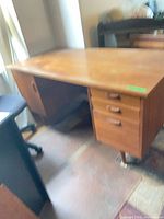 Full view of desk showing top, right drawer pedestal, left cabinet