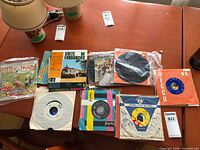 Mix of 7-inch singles with picture sleeves on table