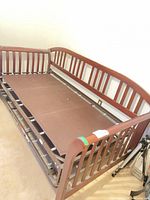 Wood daybed frame with metal trundle setup
