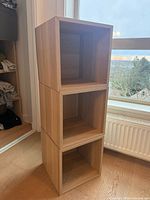 Three stacked Eket cubes showing wood finish and open fronts