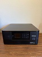 Front view of Epson XP-6100 printer showing control panel and branding