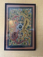 Full view of framed Aboriginal goanna tea towel artwork