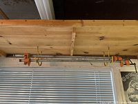 Two Pony pipe bar clamps on overhead rack