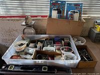 Overall lot showing tote of hardware, spray gun kits, scale, additional box of sockets