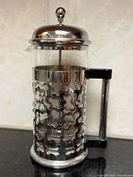 Full view showing sleeve pattern, glass beaker, lid, handle