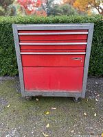 Front view showing red drawer fronts and overall cabinet
