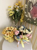 All three faux flower arrangements on tabletop