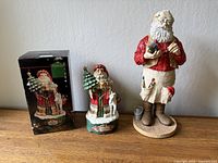Both Santa figurines with box shown side by side