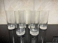 Front view of six Orrefors Duncan highball glasses showing stacked bases